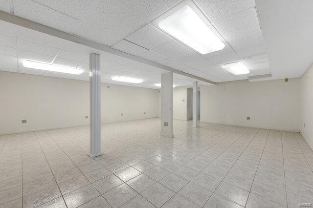 basement featuring a paneled ceiling