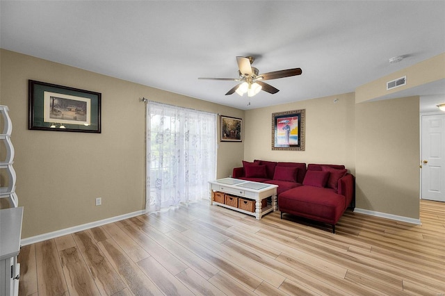 living room featuring ceiling fan and light hardwood / wood-style flooring