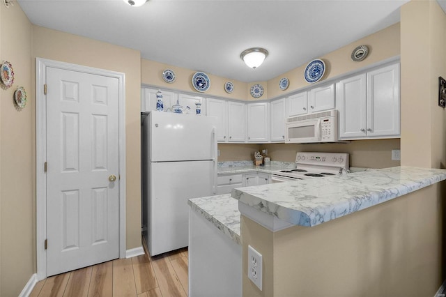 kitchen featuring kitchen peninsula, white cabinetry, light hardwood / wood-style floors, and white appliances