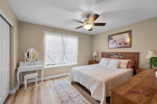 bedroom featuring ceiling fan, a closet, and light hardwood / wood-style flooring