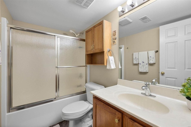 full bathroom featuring combined bath / shower with glass door, vanity, and toilet