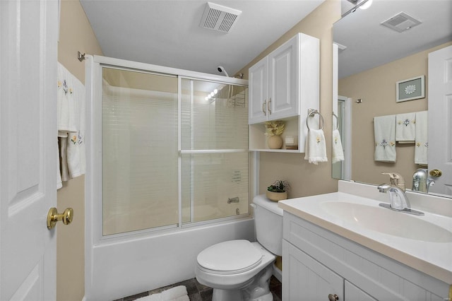 full bathroom with combined bath / shower with glass door, vanity, and toilet