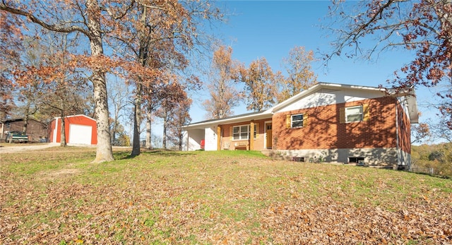 exterior space with a garage, an outdoor structure, and a front yard