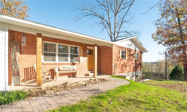 rear view of property featuring covered porch