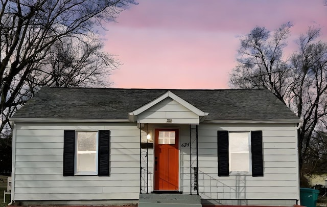 bungalow-style house with a shingled roof