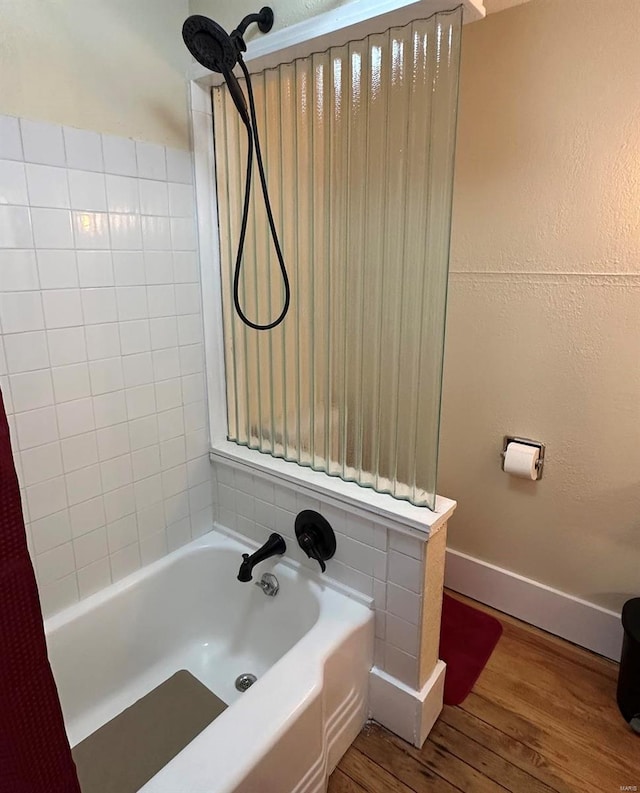 bathroom with wood-type flooring and shower / bathtub combination