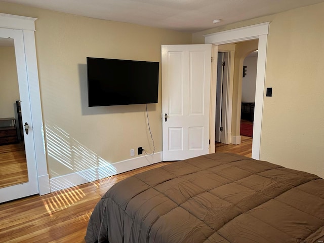 bedroom with hardwood / wood-style floors