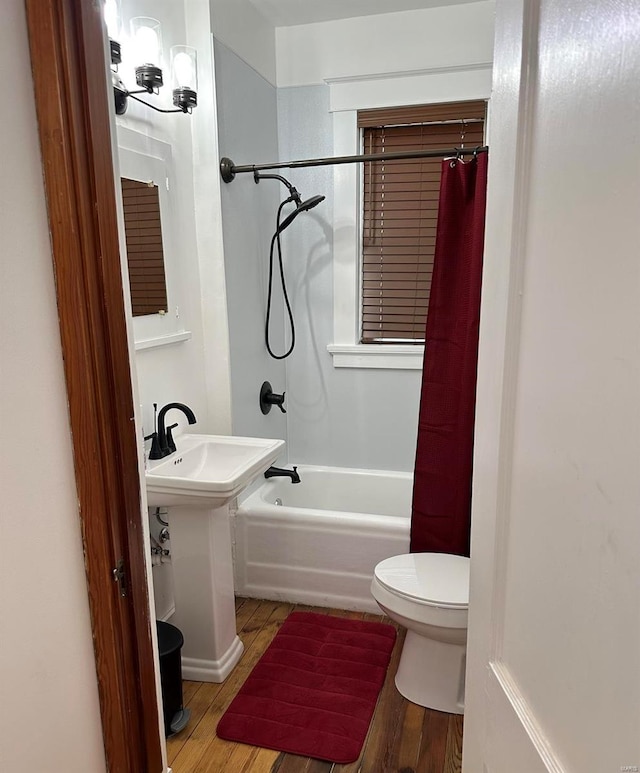 bathroom featuring toilet, shower / bath combination with curtain, and hardwood / wood-style flooring