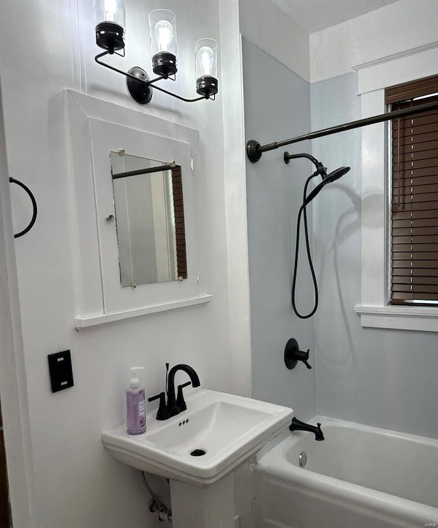 bathroom featuring shower / bathtub combination and sink