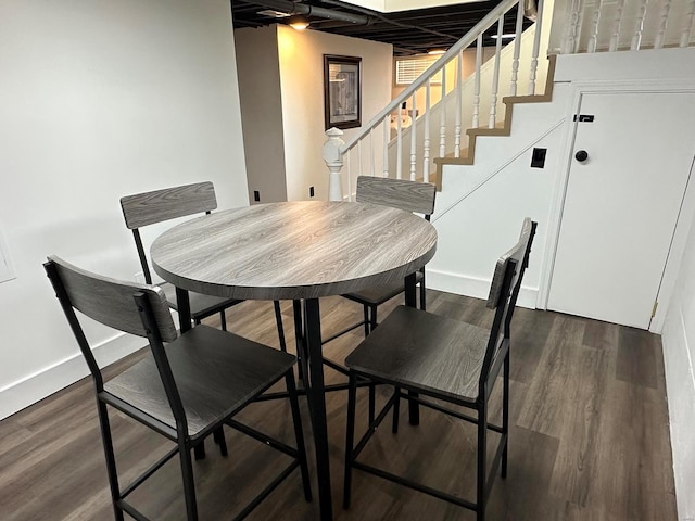 dining space with dark hardwood / wood-style flooring