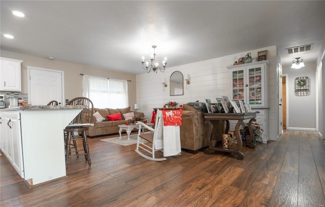 living room featuring dark hardwood / wood-style flooring and a notable chandelier