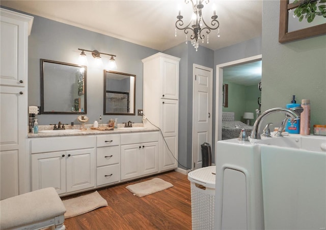 bathroom featuring hardwood / wood-style flooring, vanity, and a notable chandelier