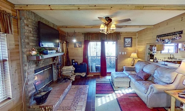 living room with beamed ceiling, plenty of natural light, and wood walls