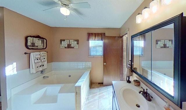 bathroom featuring vanity, tile patterned floors, ceiling fan, and a bathing tub