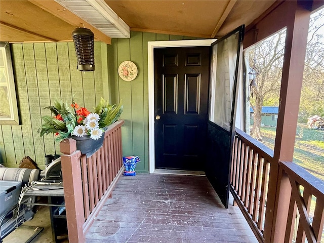 view of exterior entry featuring a balcony