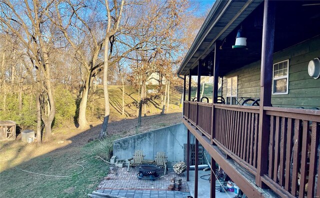 exterior space featuring an outdoor fire pit and a patio