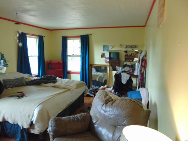 bedroom featuring hardwood / wood-style flooring and ornamental molding