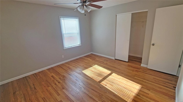 unfurnished bedroom featuring ceiling fan, a closet, and light wood-type flooring