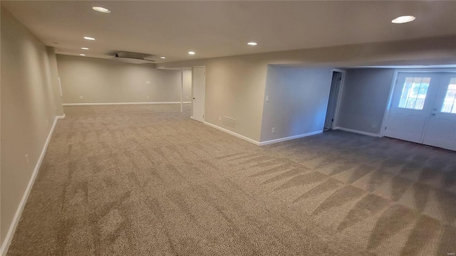 basement featuring french doors and carpet floors