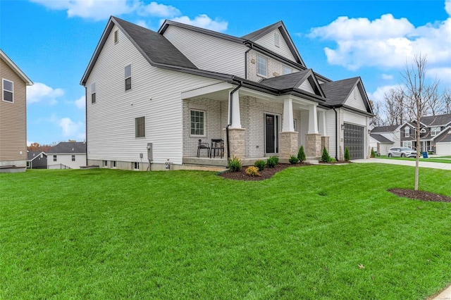 view of front facade with covered porch, a garage, and a front yard