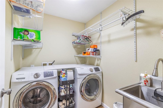 laundry area featuring independent washer and dryer and sink