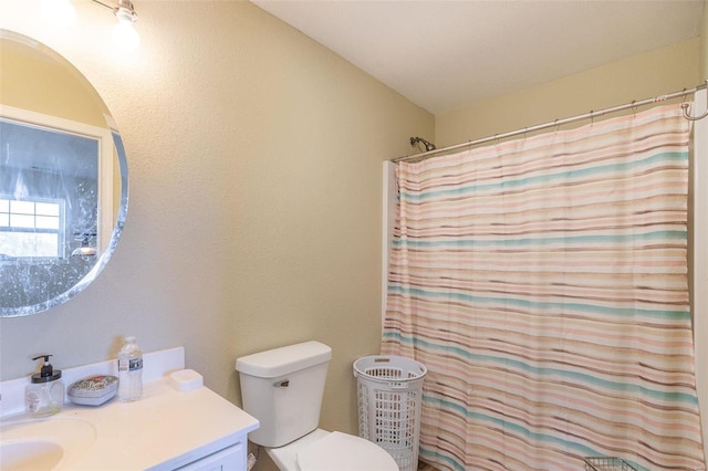 bathroom with a shower with curtain, vanity, and toilet