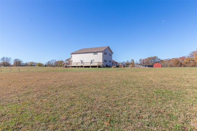 view of yard with a rural view and a deck