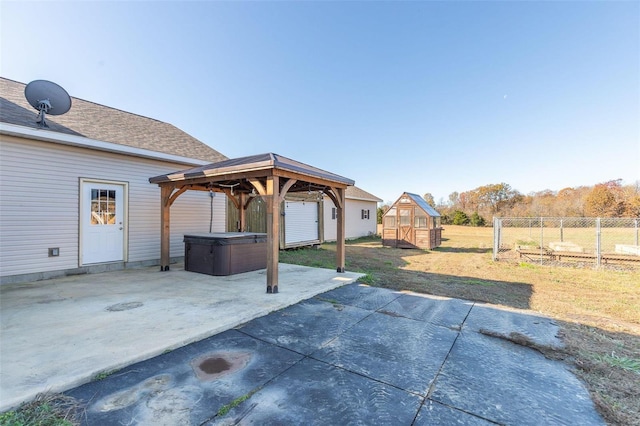 view of patio / terrace with a gazebo and an outbuilding