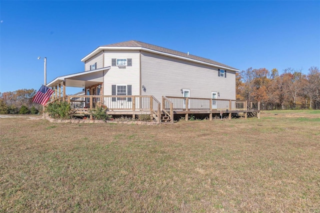 rear view of house with a lawn and a wooden deck