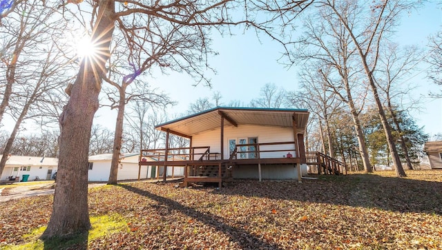 back of house featuring a deck