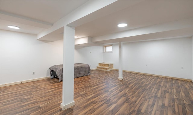 basement with dark hardwood / wood-style flooring