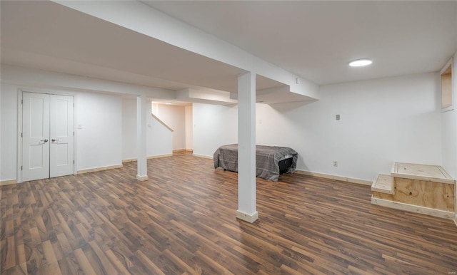 basement with dark hardwood / wood-style flooring