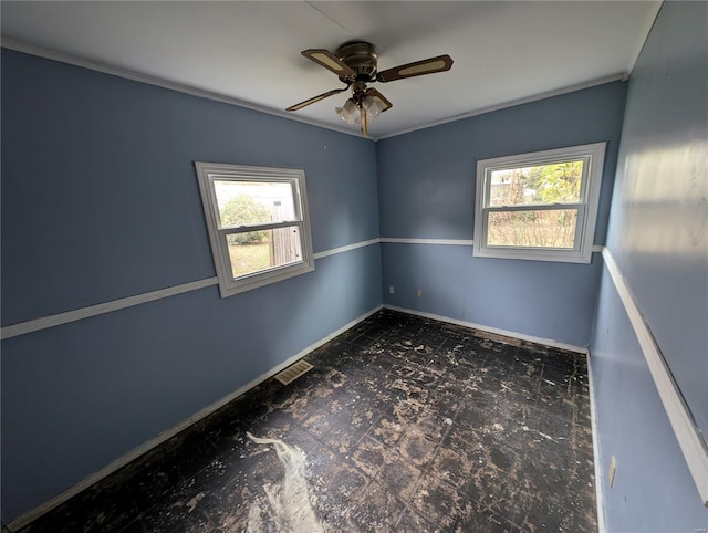 empty room featuring ceiling fan and a healthy amount of sunlight