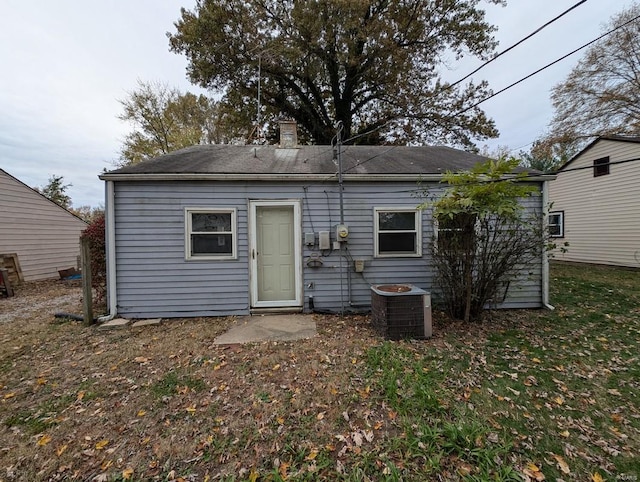 rear view of house featuring cooling unit