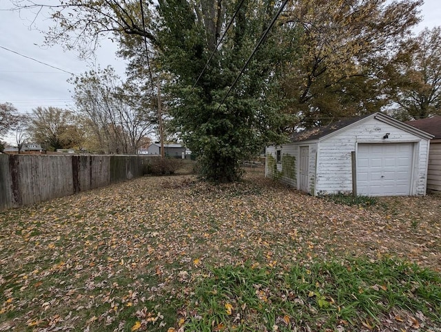 view of yard featuring an outbuilding and a garage