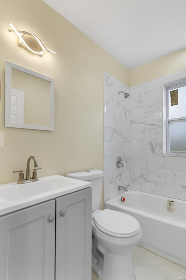 full bathroom with tiled shower / bath combo, toilet, and vanity