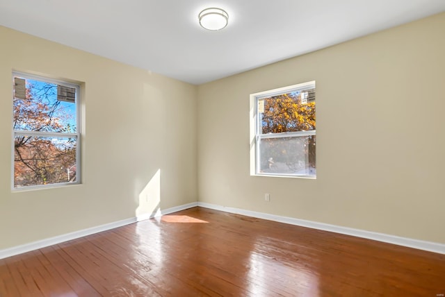 unfurnished room featuring hardwood / wood-style flooring