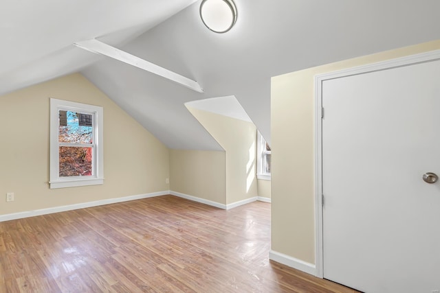 bonus room with plenty of natural light, light hardwood / wood-style floors, and lofted ceiling