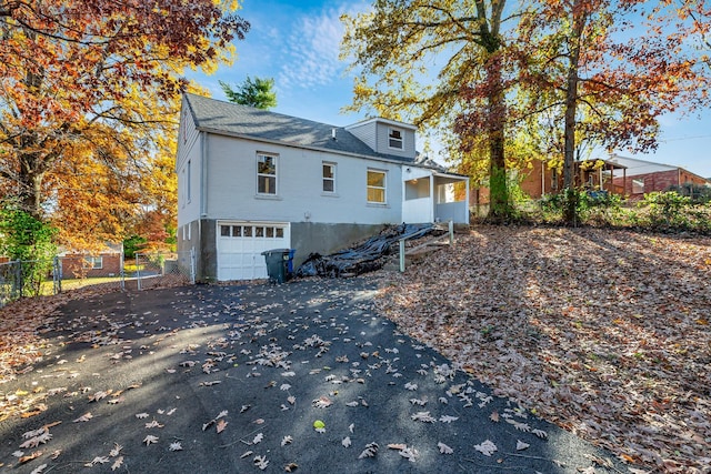 back of house featuring a garage