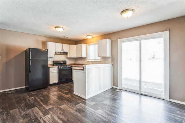 kitchen featuring white cabinetry, a healthy amount of sunlight, and black appliances