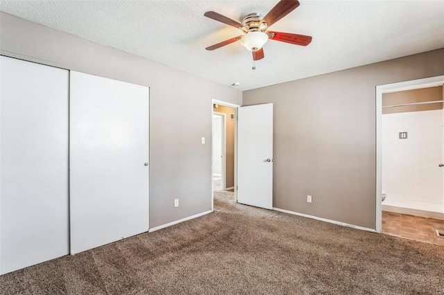 unfurnished bedroom featuring carpet, ceiling fan, a textured ceiling, and a closet