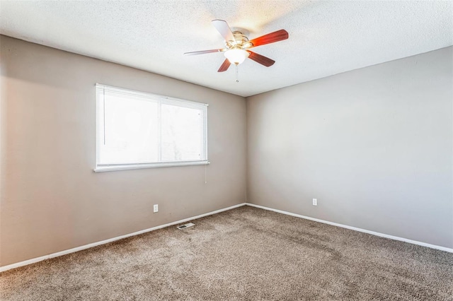 spare room with ceiling fan, carpet floors, and a textured ceiling