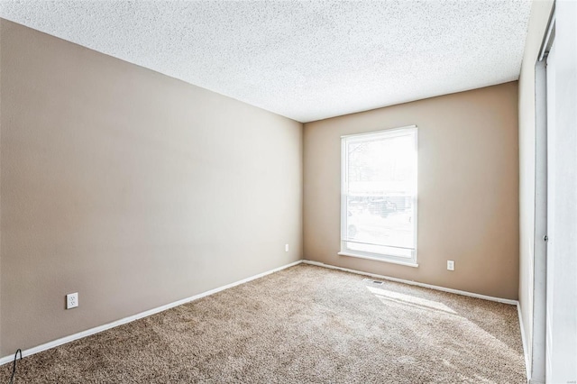 unfurnished room featuring carpet floors and a textured ceiling