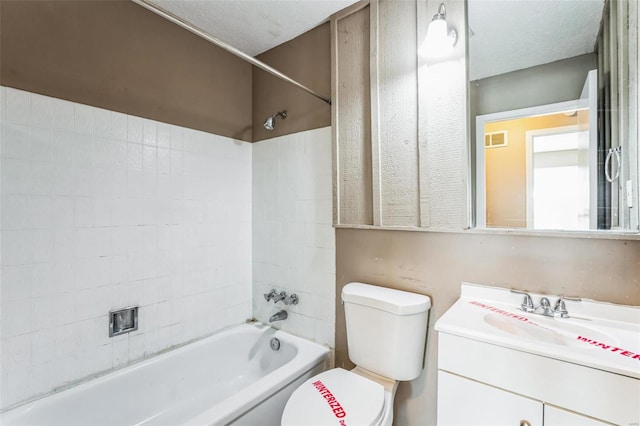 full bathroom featuring vanity, shower / bath combination, a textured ceiling, and toilet