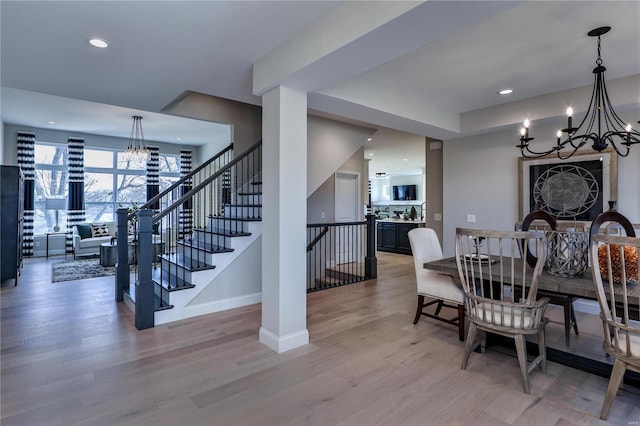 dining space featuring hardwood / wood-style floors and a notable chandelier