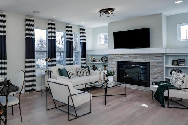 living room with hardwood / wood-style flooring and a fireplace