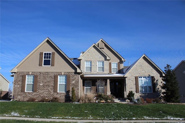 craftsman inspired home with covered porch and a front yard