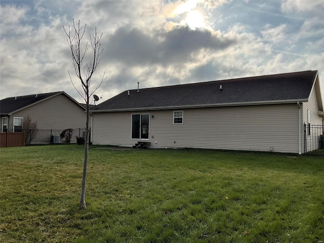 back of house featuring a yard