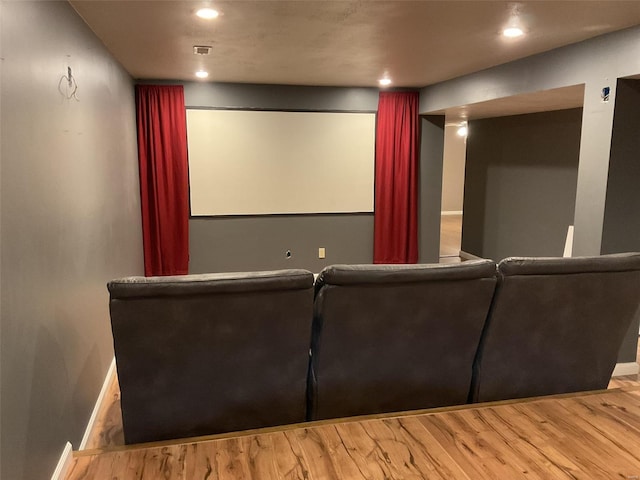 home theater room featuring hardwood / wood-style floors