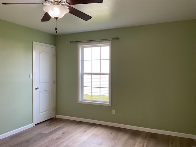 spare room with light hardwood / wood-style floors and ceiling fan